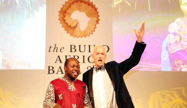 Channel 4 News host Jon Snow joins Build Africa's Anslem Wandega for a duet